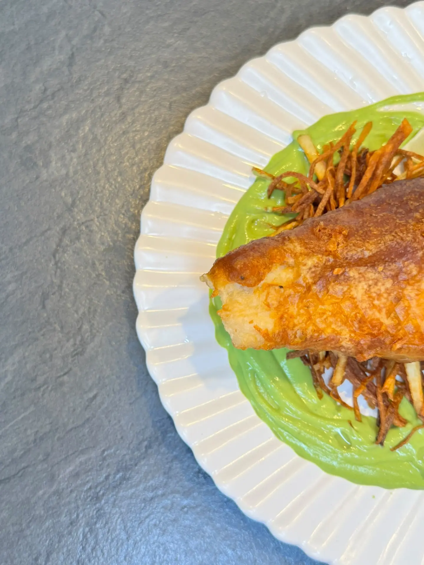 Crisp golden cod with pea purée and shoestring fries