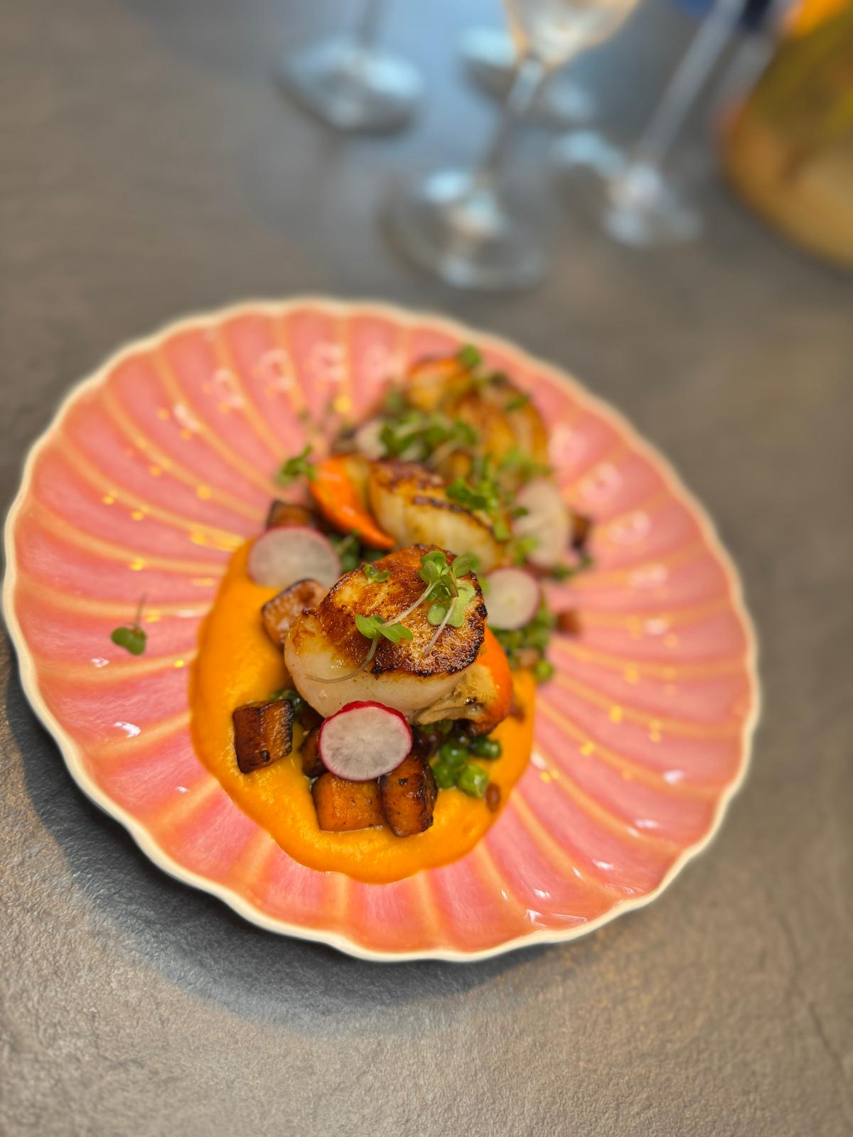 Michelin-style dish being finished by a private chef