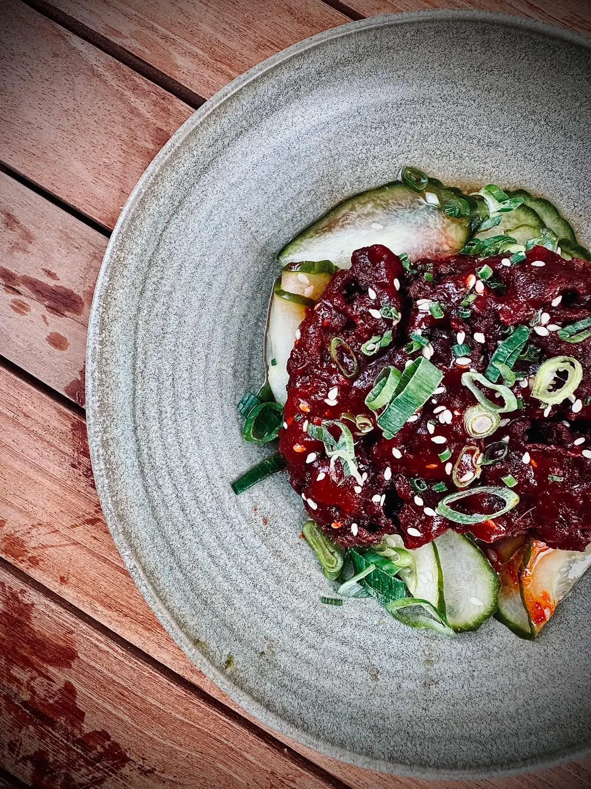 Gochujang glazed beef with pickled cucumber and sesame