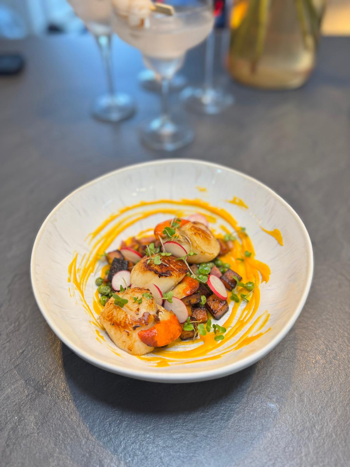 Seared scallops with squash purée and garden peas