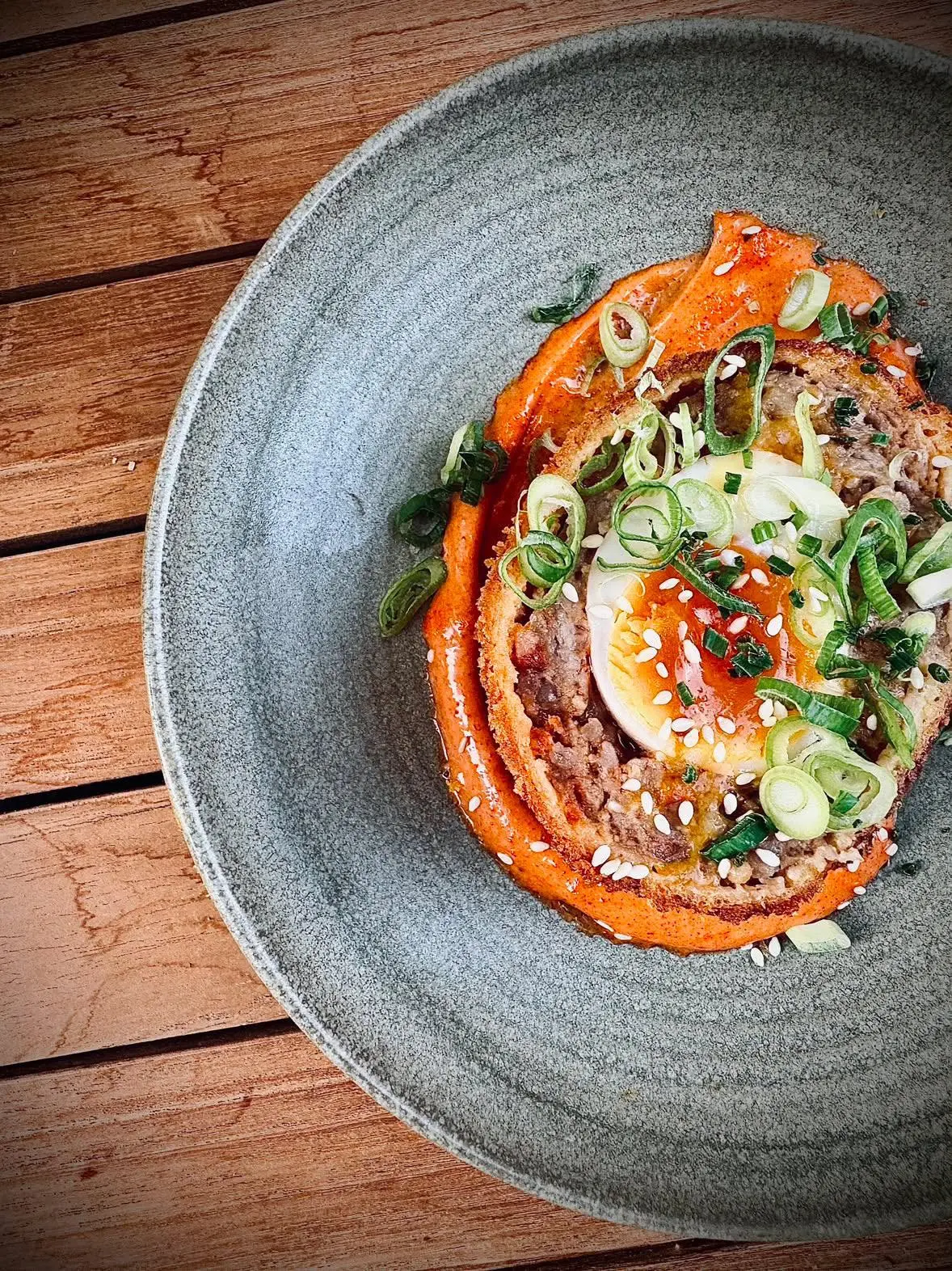 Scotch egg with smoked paprika aioli and spring onion